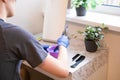 Hair dye preparation. Man hands preparing a hair dye in a plastic container Royalty Free Stock Photo