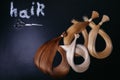 Hair extensions of three colors on a dark background. copyspace. top view.