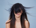 Hair freedom. Studio shot of young woman with wind-swept hair. Royalty Free Stock Photo