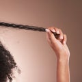 Hair in hands, afro beauty and black woman on brown background for wellness, shine and natural glow. Salon, luxury Royalty Free Stock Photo