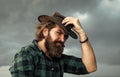 Hair like fire. cowboy bearded man in checkered shirt. hairdresser salon concept. wild west texas. mature brutal hipster