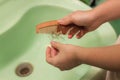 Hair loss and hair care. Hands holding a comb and hair. The girl is combing her hair in the bathroom and a lot of hair fell out Royalty Free Stock Photo