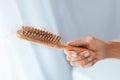 Hair Loss. Hairbrush With Lost Hair In Hand Closeup