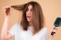 Hair loss woman with a comb and problem hair. Hairloss stressed woman and bald problems.