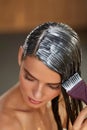 Hair Masks. Woman Applying Mask With Brush On Wet Long Hair Royalty Free Stock Photo