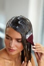 Hair Masks. Woman Applying Mask With Brush On Wet Long Hair Royalty Free Stock Photo