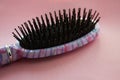 Hair massage comb brush with handle for all types isolated on pink pastel copy space background. Minimalistic style Royalty Free Stock Photo