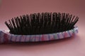 Hair massage comb brush with handle for all types  on pink pastel copy space background. Minimalistic style Royalty Free Stock Photo