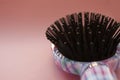 Hair massage comb brush with handle for all types  on pink pastel copy space background. Minimalistic style. Royalty Free Stock Photo