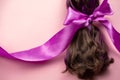 hair with purple strands tied in a ponytail with pink satin ribbon, hair loss during cancer, hairstyles and hair care