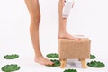 Hair removal. Fit young woman waxing her legs with a portable roll-on depilatory wax heater for painless. Skin care Royalty Free Stock Photo