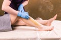 Hair removal at spa luxury shop. Women legs wax with sugaring. Hot sugar.