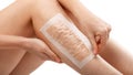 Hair removal with wax strips. Epilation of the legs at home. The girl removes unwanted hair on her legs in close-up