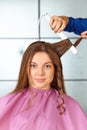 Hair salon. Woman haircut. Use of straightener.