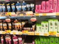 Hair shampoo in plastic bottle packaging, on display for sale on the shelves in the supermarket.