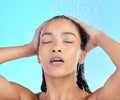 Hair, shower and black woman in studio for skincare, wellness and grooming on blue background. Beauty, washing and hair Royalty Free Stock Photo