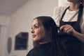 Hair that slays starts at the salon. a beautiful young woman doing her hair at the salon.