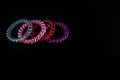 Hair spiral scrunchies on black background. Colorful scrunchies isolated Royalty Free Stock Photo