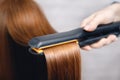 Hair straightening iron in beauty salon Royalty Free Stock Photo