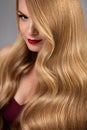 Hair Style. Beautiful Woman With Healthy Wavy Long Blonde Hair Royalty Free Stock Photo