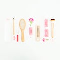 Hair styling concept with tools, curlers and shampoo on white background. Beauty composition. Flat lay, top view Royalty Free Stock Photo