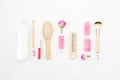 Hair styling concept with tools, curlers and shampoo on white background. Flat lay, top view Royalty Free Stock Photo