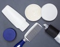 Hair styling products with comb on gray background Royalty Free Stock Photo