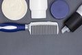 Hair styling products with comb on gray background Royalty Free Stock Photo
