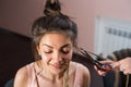 A hair stylist cuts Zizi cornrows from young and beautiful girl Royalty Free Stock Photo