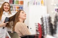 Hair stylist drying hair for female client Royalty Free Stock Photo