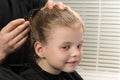 Hair stylist fixes with a hairpin hairstyle for a girl