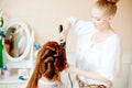 Hair stylist makes the bride on the wedding day Royalty Free Stock Photo