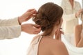 Hair stylist preparing bride for her wedding indoors Royalty Free Stock Photo