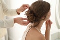 Hair stylist preparing bride for her wedding indoors Royalty Free Stock Photo