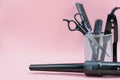 hair stylist tools in a basket. scissors, brush, comb. curling iron Royalty Free Stock Photo