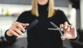 Hair stylist woman hands hold scissors and comb close up. Hairdressing and hair care Royalty Free Stock Photo