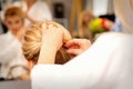 Hair stylist& x27;s hands doing professional hairstyling of female long hair in a beauty salon.