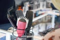 Hair tools, different Hair Brushes, Combs, Piks in the stand on the salon store