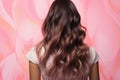 Hair transformation Model\'s back view Æ?? repair, shine, volume emphasized on pink backdrop.