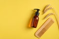 Hair treatment concept. Flat lay cosmetic amber glass bottle dispenser with hair gel, wooden comb, wheat. Top view barley and oat Royalty Free Stock Photo