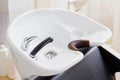 Hair wash sink for washing hair in beauty salon or Barber shop, shampoos, towels. Hairdresser stylist work space. Hairdressing Royalty Free Stock Photo