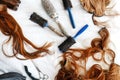 Hairbrushes and false hair with scissors.