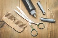 Hairbrushes, sprayer, curlers and a scissors on a wooden board, top view Royalty Free Stock Photo