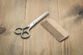 Hairbrushes, sprayer and a scissors on a wooden board, barbershop concept Royalty Free Stock Photo