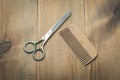 Hairbrushes, sprayer and a scissors on a wooden board, top view Royalty Free Stock Photo