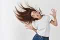 Haircare and beauty concept. Happy young woman dancing and whip healthy shiny hair, having fun, standing joyful over Royalty Free Stock Photo