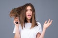 Haircare. Straightening woman with straight brushed hair. Hair tangling problem. Unhappy girl with tangled hair. Damaged