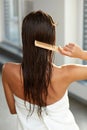 Haircare. Woman Brushing Beautiful Long Healthy Hair With Comb Royalty Free Stock Photo