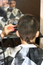 Haircut of a boy at the hairdresser. Trimer. Royalty Free Stock Photo