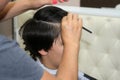 Haircut of a boy at the hairdresser. Trimer. Royalty Free Stock Photo